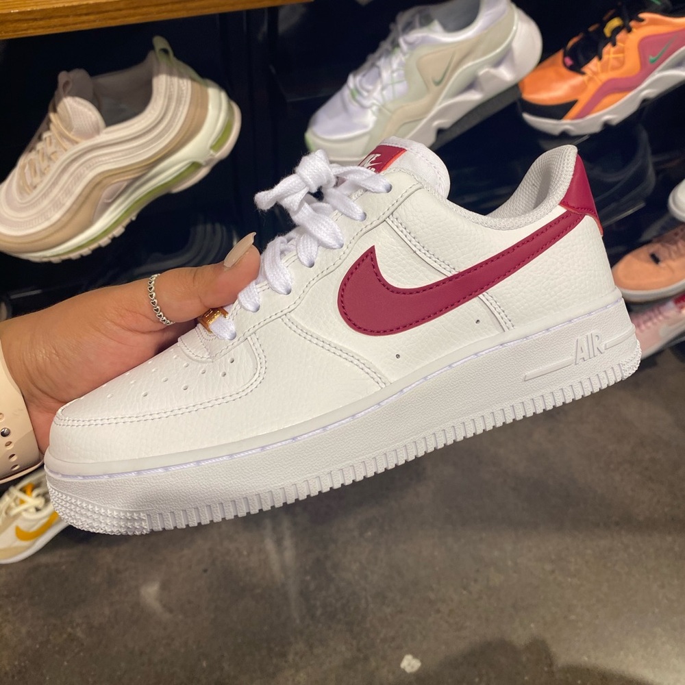 Nike Air Force 1s with red swoosh